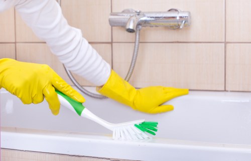 Carpet cleaner applying treatment during a residential service