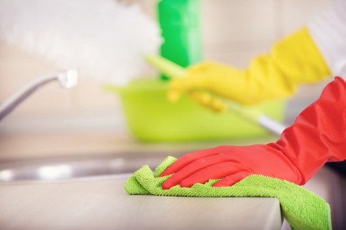 Local cleaner treating stains on a sofa in Maidavale
